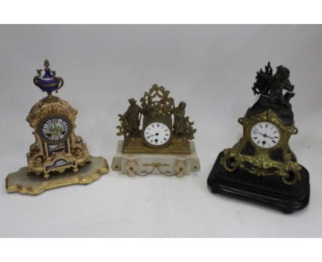 Three French mantel clocks, including an ormolu and onyx figural example, an ormolu and spelter cherub clock, and a gilt and 