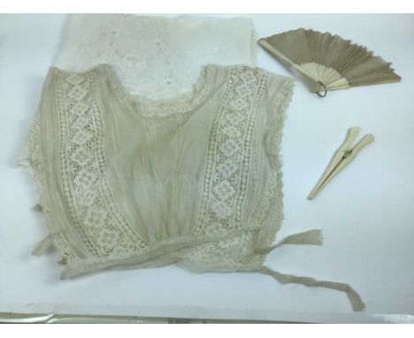 An Edwardian sleeveless cropped lace blouse, small lace collars and cuffs, lace lengths, a quantity of lace mats in a circula