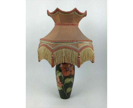 Moorcroft pottery table lamp decorated in the Hibiscus pattern on green ground, impressed marks to base and original paper la