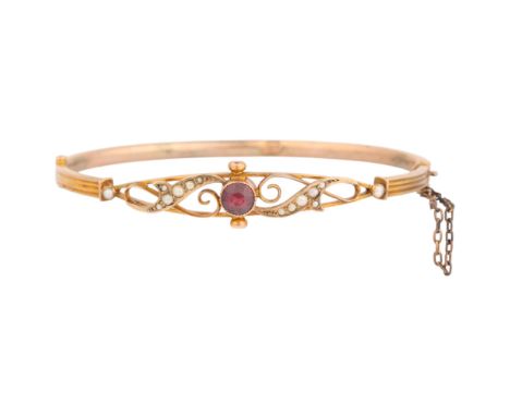 An Antique Victorian 9ct rose gold garnet and split pearl hinged bangle, rub-over set with round-cut garnet flanked by openwo