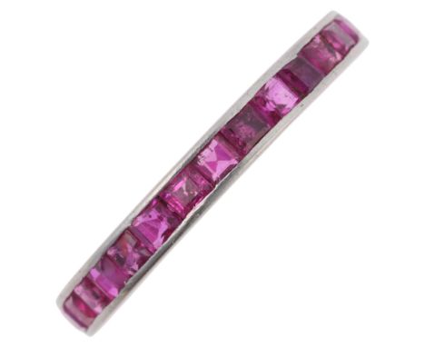 An Art Deco platinum ruby full eternity ring, channel set with calibre-cut rubies, unmarked mount tests as platinum, band wid