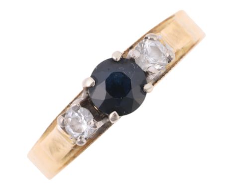 An 18ct white gold three stone sapphire and cubic zirconia ring, setting height 4.3mm, size M, 3.2g . Condition Report:No dam
