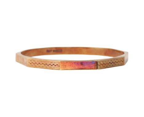 A large Art Deco 15ct gold bangle, T & H Crathorne Ltd, Birmingham 1927, faceted form with engine turned and polished decorat