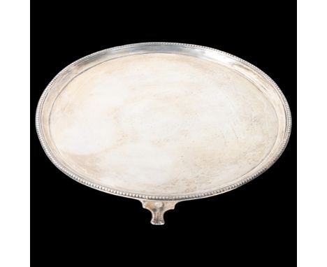 A George III silver salver, Thomas Graham & Jacob Willis, London 1810, circular form, with beaded edge raised on 3 feet, 25.5