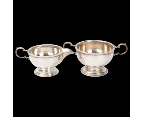 A George V silver matching cream jug and sugar bowl, Marson & Jones, Birmingham 1930, circular form with beaded edge, bowl he