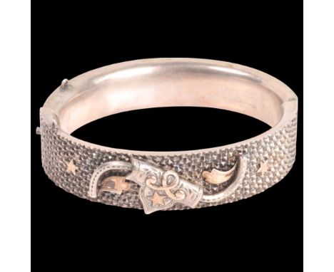 An Antique Victorian silver 'Turkish Market' hinged bangle, unmarked, band width 15.6mm, internal circumference 17cm, 25.7g .