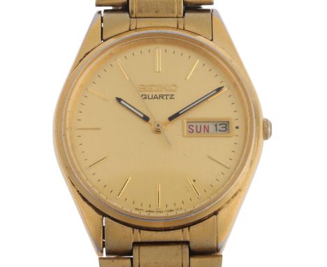 SEIKO - a gold plated stainless steel quartz calendar bracelet watch, ref. 7N43-7A50, champagne dial with baton hour markers,