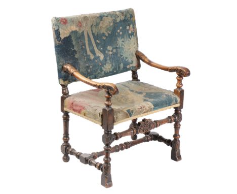 The rectangular padded back and stuff-over seat upholstered in 17th century tapestry fragments, designed with animals, includ