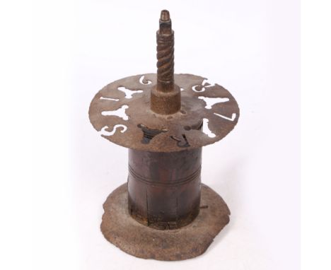 Having a short threaded bar, atop an iron circular plate pierced with the initials ‘R S’ and the date ‘1687', 32cm high.
