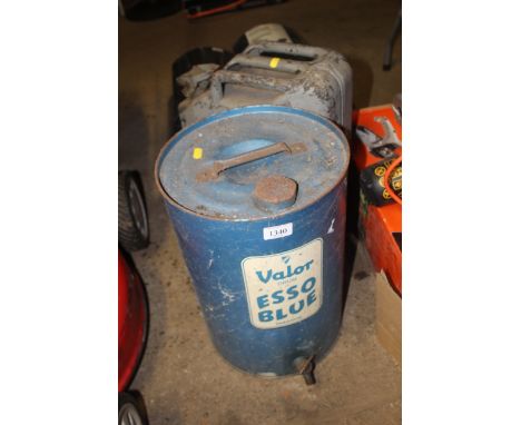 A metal jerry can and Valor Esso blue paraffin can