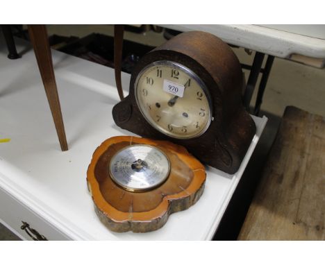 An oak cased two hole mantle clock and a barometer