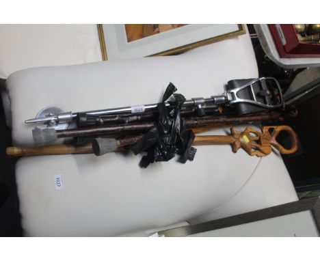 A collection of walking sticks and a shooting stick