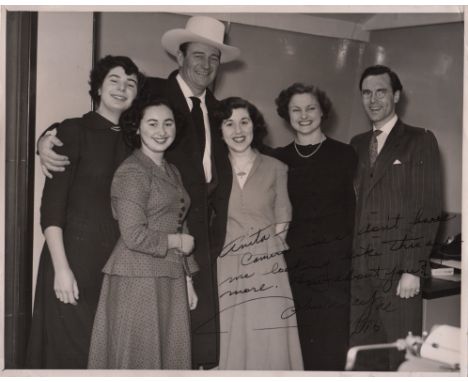  WAYNE JOHN: (1907-1979) American Actor, Academy Award winner. Signed and inscribed 10 x 8 photograph of Wayne standing in a 
