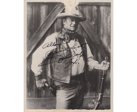 WAYNE JOHN: (1907-1979) American Actor, Academy Award winner. Signed and inscribed 8 x 10 photograph of Wayne standing in a t