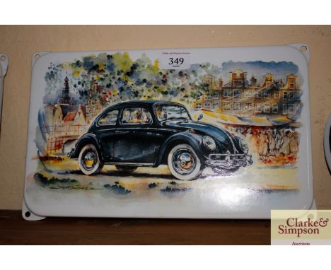 An enamel replica sign depicting a Volkswagen Beetle