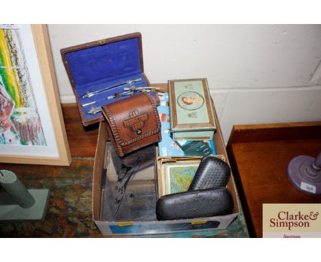 A box of miscellaneous items to include Queens Coronation tin, glass coasters, vintage spectacles, drawing instruments, car i
