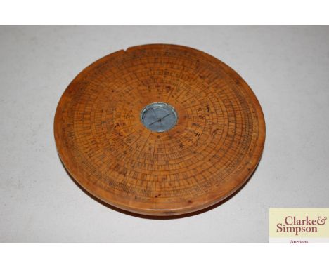 A Chinese compass with wooden surround 