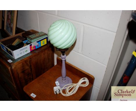 An Art Deco painted wooden table lamp, having opaque green glass shade 