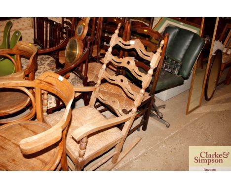 An elm ladder back and rush seat rocking chair