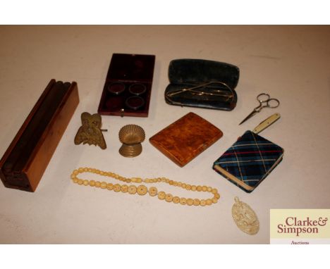 A box containing a burr wood snuff box, costume jewellery, folding easel, lenses etc.