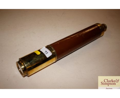 A vintage brass and leather mounted two draw telescope 
