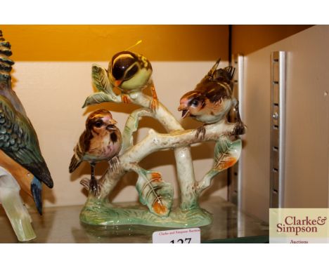 A Goebel porcelain group depicting three birds on a branch 