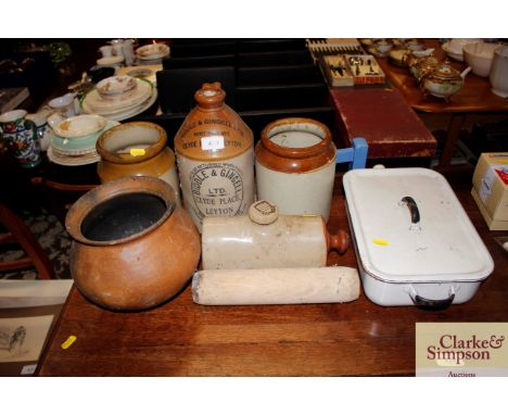 A stone glazed flagon by Biddell &amp; Gingel Ltd.; two storage jars; a stone glazed hot water bottle; an enamel pan and lid 