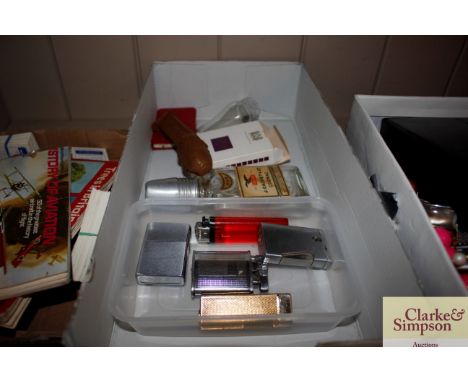 A box containing various lighters, a box of Silk Cut playing cards etc.