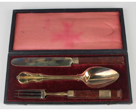A mid-19th century Russian silver gilt three-piece cutlery set, 84 zolotnik, comprising knife and fork, each with an agate ha