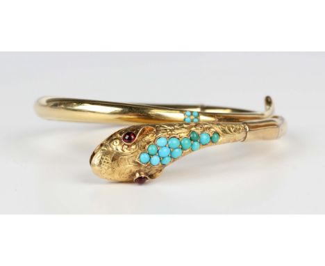 A Victorian gold, turquoise, carbuncle garnet and pale blue gem set hinged bangle, designed as a snake with engraved decorati
