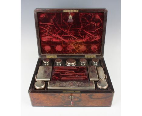 An early Victorian brass mounted rosewood vanity box, the hinged lid opening to reveal a compartmentalized interior fitted wi