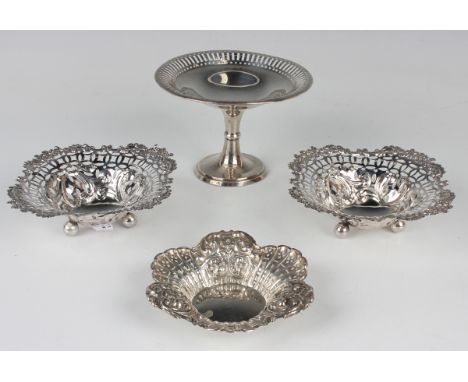 A pair of late Victorian silver shaped square bonbon dishes, each with pierced sides and floral embossed rims, raised on ball