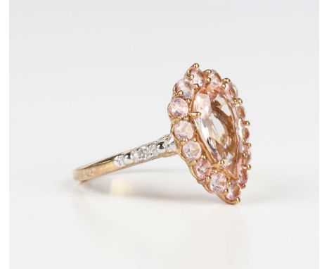 A 9ct gold, morganite and diamond cluster ring, claw set with the pear shaped morganite within a surround of circular cut mor