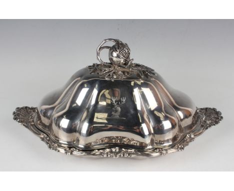 An early Victorian silver entrée dish and cover, the shallow dish with cast foliate scroll, flowerhead and scalloped rim, fla