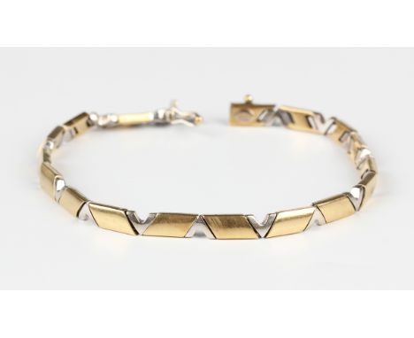 A two colour gold bracelet with alternating rhombus and 'V' shaped links, on a snap clasp, detailed '750', weight 17.3g, leng