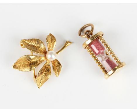 A gold and cultured pearl brooch, designed as a foliate spray, detailed '585', weight 3.9g, width 2.2cm, and a gold mounted e