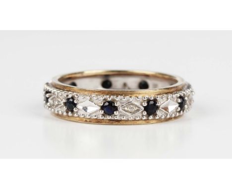 A two colour gold, sapphire and diamond eternity ring with beaded decoration, detailed '375 DIA', weight 2.7g, ring size appr