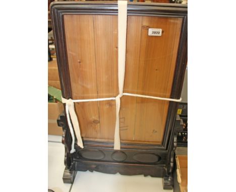 Chinese firescreen comprising an ornately carved wooden frame with glass insert and an embroidered silk centre piece depictin