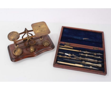 Set of late 19th/early 20th century brass postal scales, with four weights, on a wooden base, together with a cased set of dr