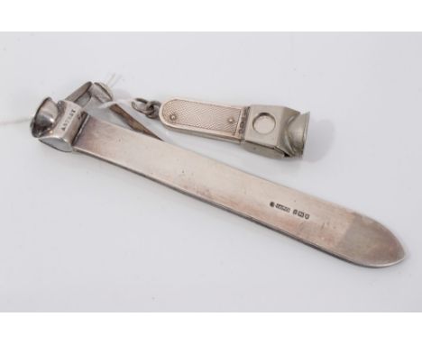 Edwardian Asprey &amp; Co silver cigar cutter (London 1910), 14cm long, together with another with engine turned decoration (