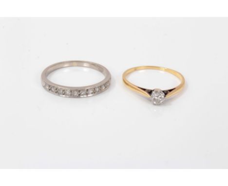Single stone diamond ring in claw setting on yellow metal shank, size L, together with a diamond set half eternity ring, size