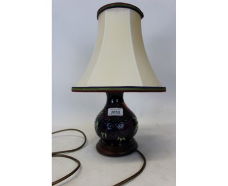 Modern Moorcroft lamp decorated in the Anemone pattern on blue ground, with cream shade