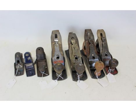 Four vintage smoothing planes - including two Acorn No. 4, one Record No. 03 and one Stanley No. 4, together with an unmarked