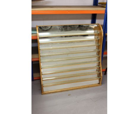 3 light oak tiered display cabinets with glass shelves.