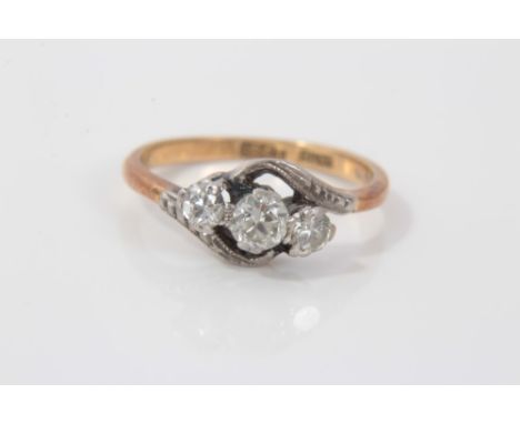 Gold (18ct) diamond three stone cross over ring in platinum setting, ring size KCondition report: weight 2.5g