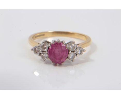 18ct gold diamond and pink stone ring with an oval cut pink tourmaline/pink sapphire flanked by six brilliant cut diamonds in