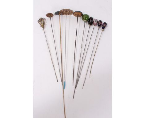 Group of eleven Edwardian and later enamel and glass mounted hatpins