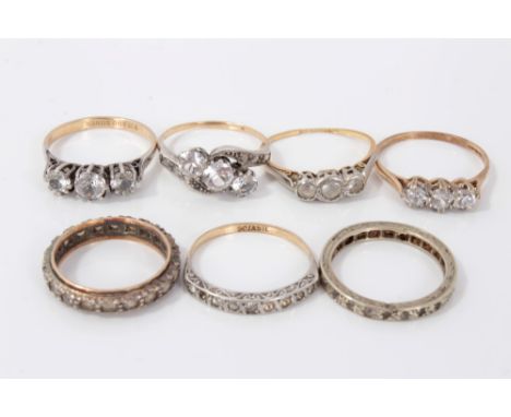 Seven gold and silver dress rings with synthetic white stonesCondition report: Gold (18ct) three stone ring has very worn sha