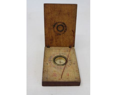 Chinese pocket compass mounted in a wooden case with Chinese character points of the compass and scales, hinged cover also wi