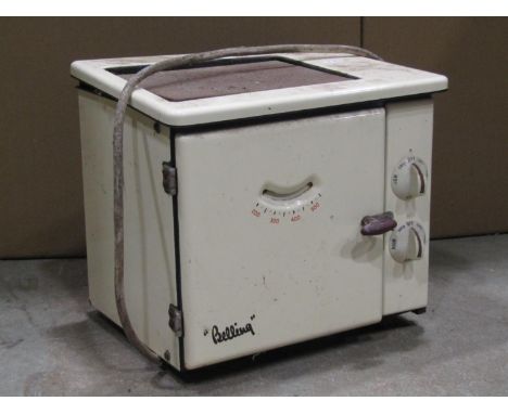 A vintage "Belling" cast iron and enamel mains electric oven and stand, together with a further smaller example (2) 